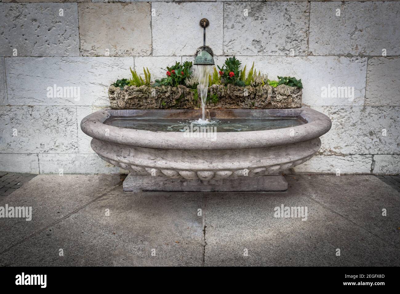Fontana d'acqua in pietra nel centro storico di Ginevra - Ginevra, Svizzera Foto Stock