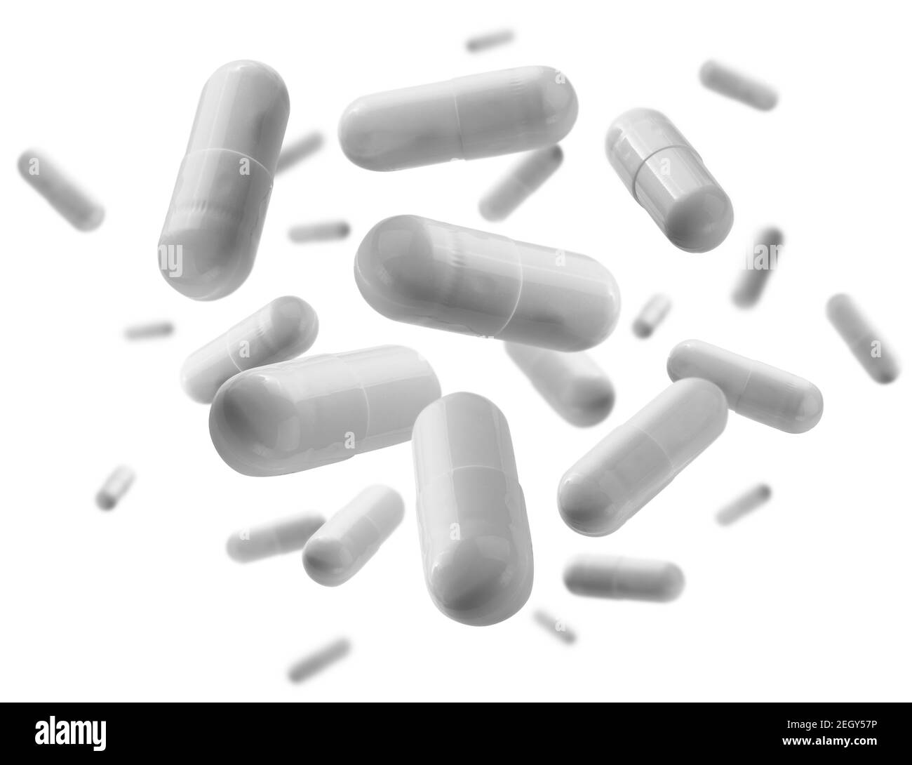 Capsule con il farmaco levitate su sfondo bianco Foto Stock