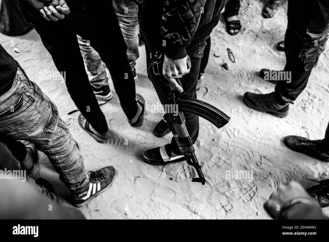 Un uomo con Kalashnikov in mano ai funerali di Jamal Affana (15 anni) è morto da una ferita da armi da fuoco durante le manifestazioni di venerdì scorso presso la recinzione di frontiera di Gaza con Israele il 13 maggio 2018 a Rafah, Gaza. Jamal è stato ucciso venerdì da un cecchino israeliano mentre partecipava alle manifestazioni. Per i 1.9 milioni di palestinesi che vivono nella striscia di Gaza, la vita è diventata una lotta quotidiana per cibo, elettricità e denaro dopo 10 anni di blocco israeliano nella regione. Finora le manifestazioni hanno provocato 40 morti palestinesi e più di 1,700 feriti dall'esercito israeliano. Prosciutto Foto Stock