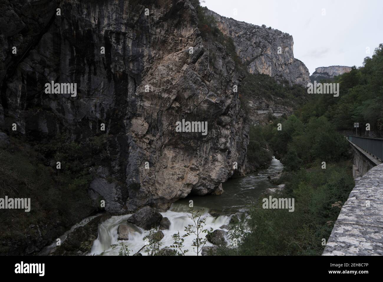 Vista lungo il fiume delle rocce a Pont-en-Royans, nella regione Auvergne-Rodano-Alpi, al crepuscolo di una giornata invernale. Foto Stock