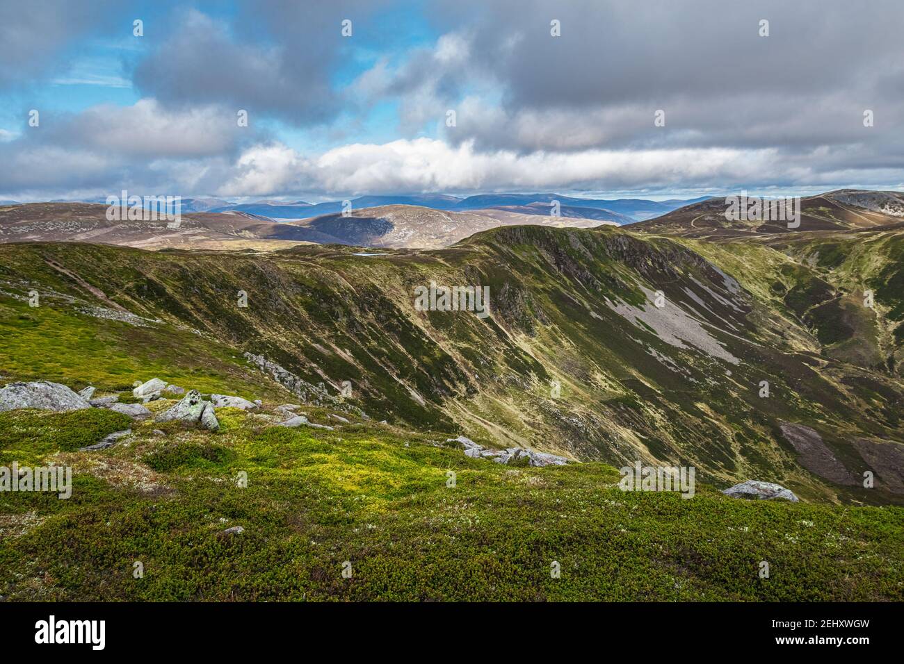 Vista panoramica sulle montagne con spazio aperto e soffici nuvole bianche all'orizzonte. Estate al Cairngorm Nationl Park nelle Highlands scozzesi. Foto Stock