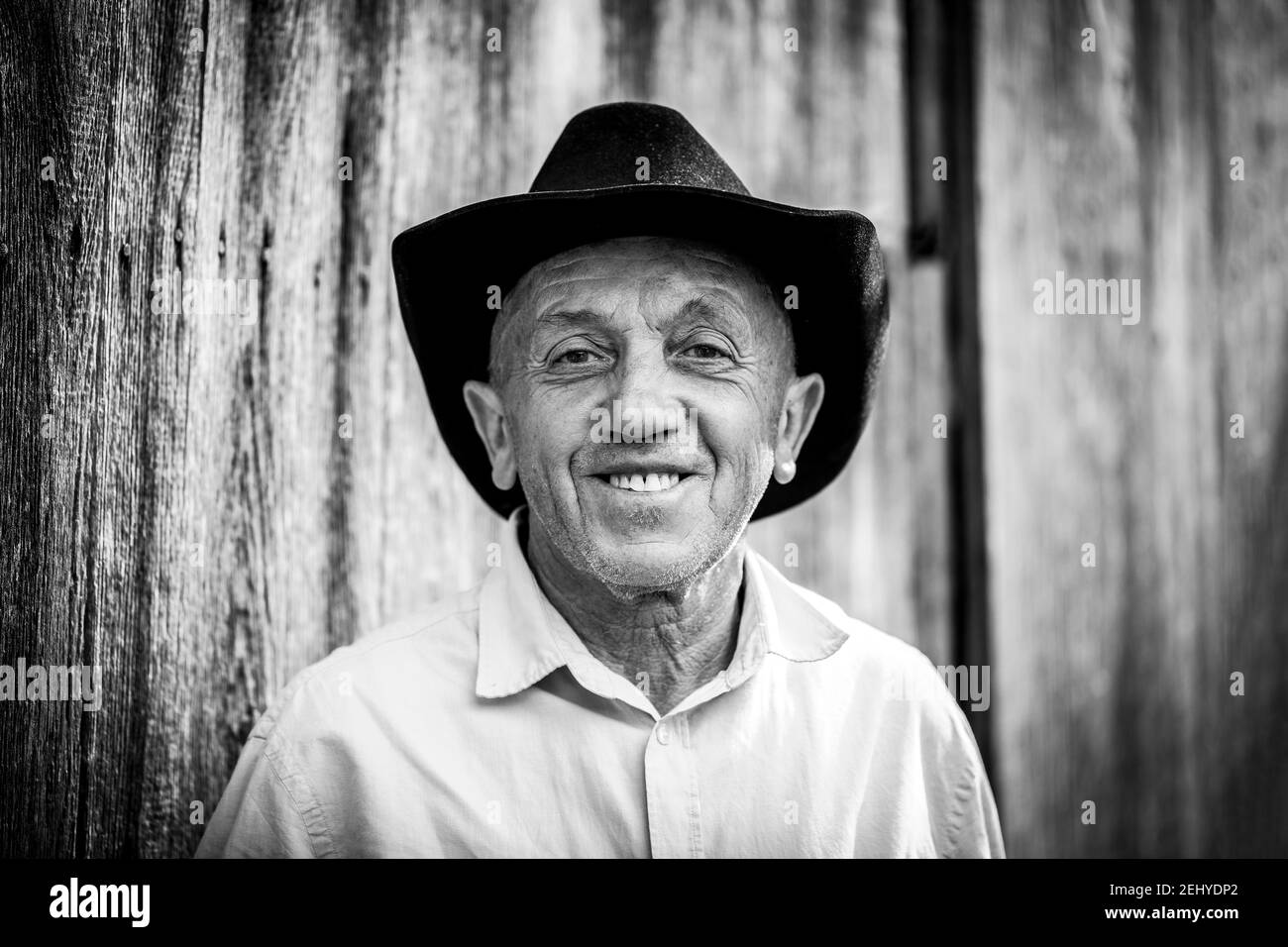 un nero e con ritratto di un uomo di campagna sorridente con un cappello da cowboy Foto Stock