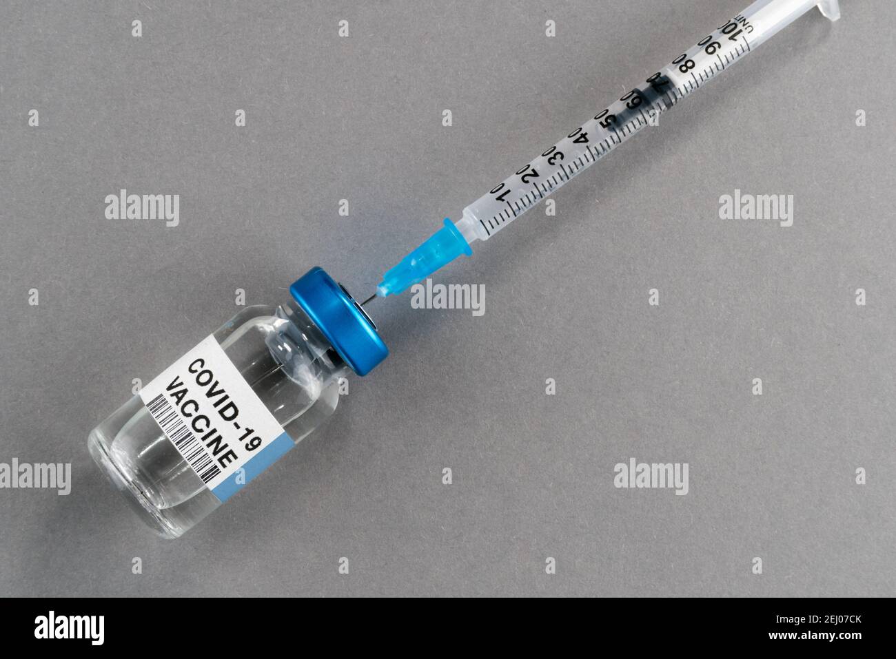 Vaccino COVID-19 del coronavirus. Flaconcino con siringa isolata su fondo grigio, composizione concettuale con spazio per la copia Foto Stock