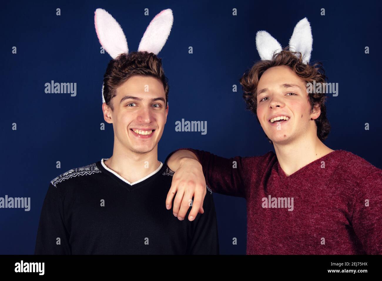 Vacanze e fine settimana. Giovane coppia attraente per Pasqua in costumi bunny. Sfondo bianco. Foto Stock