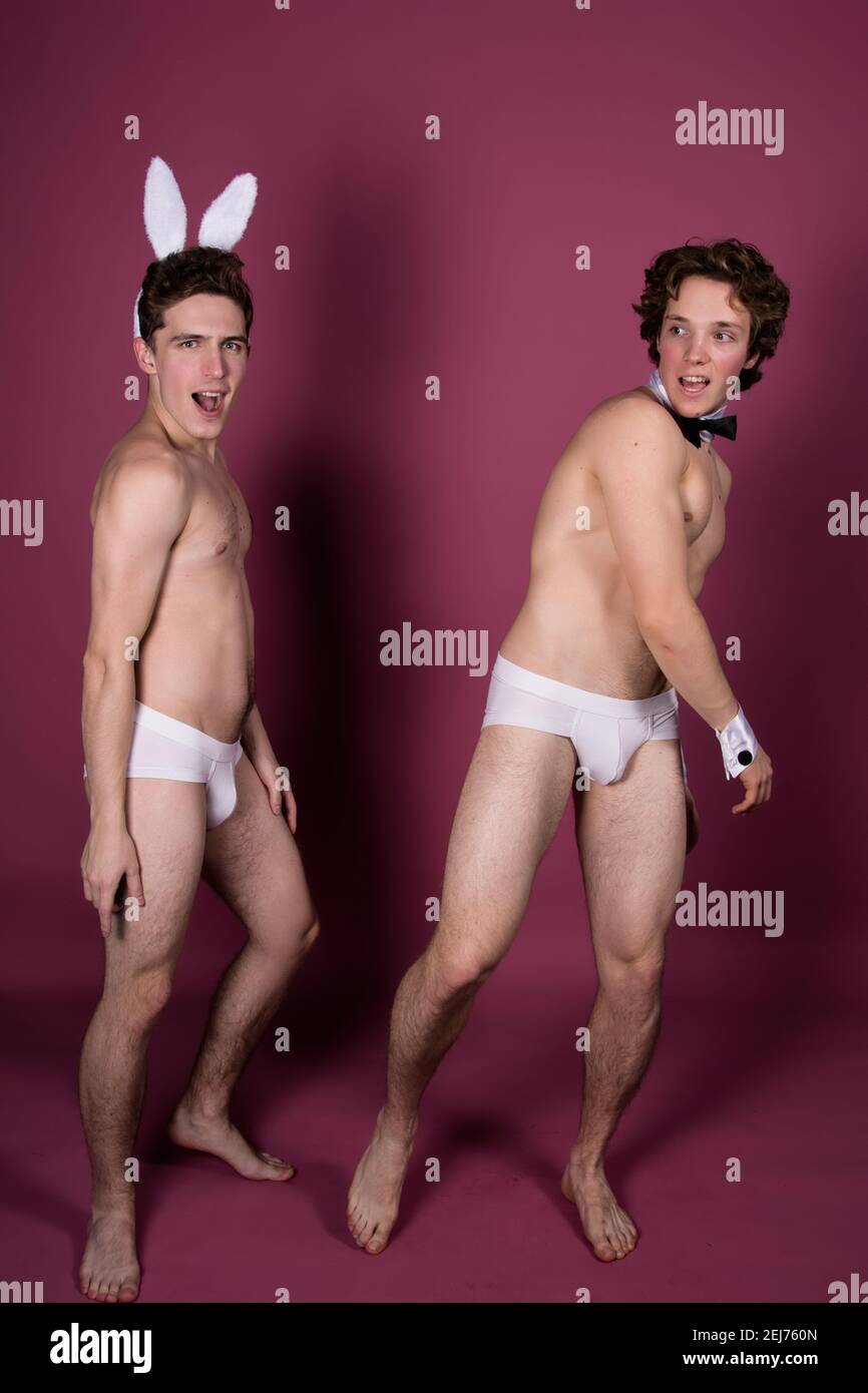 Vacanze e fine settimana. Giovane coppia attraente per Pasqua in costumi bunny. Sfondo bianco. Foto Stock