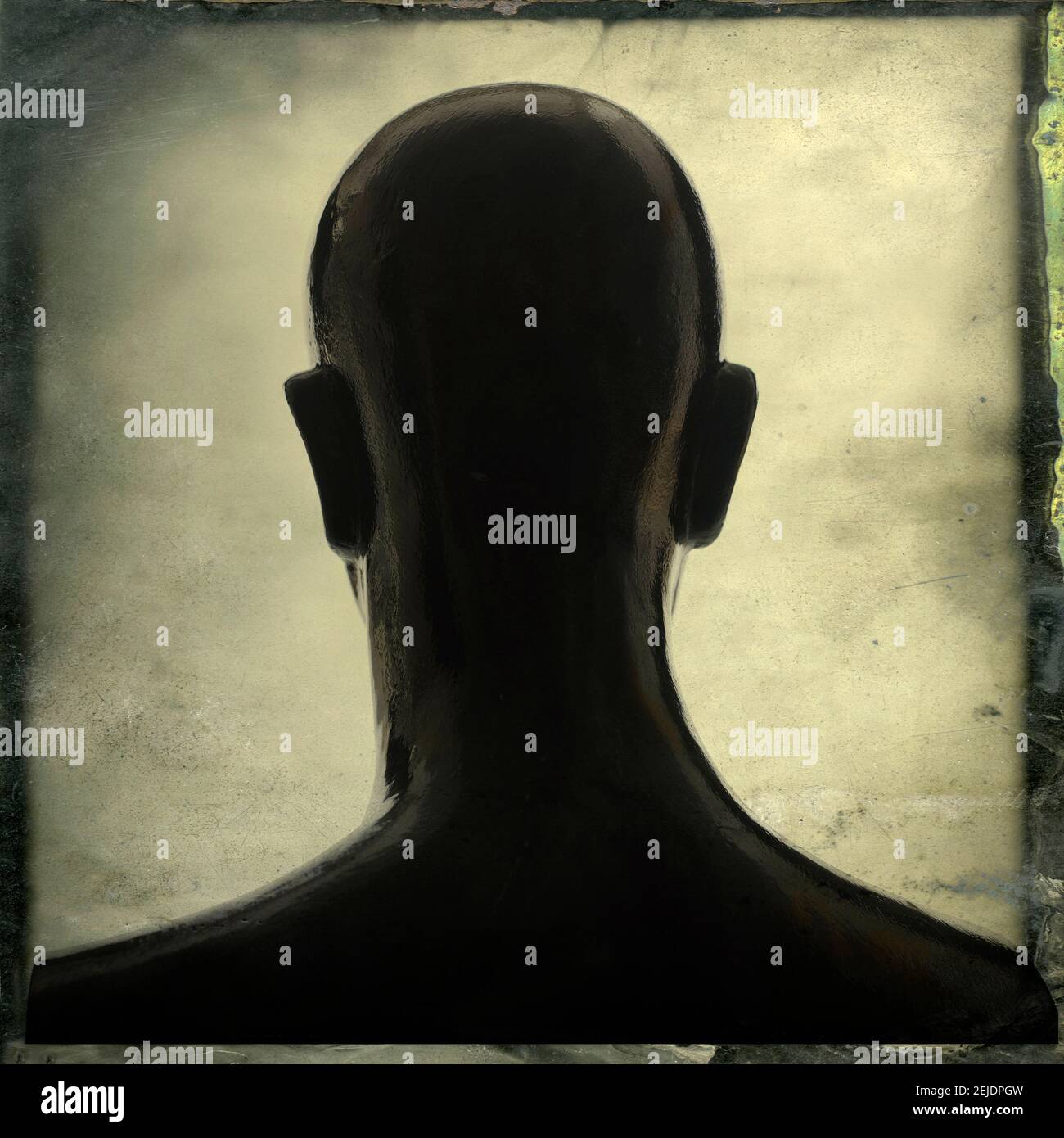Silhouette di un manichino che si affaccia su uno sfondo morbido e illuminato, creando un'atmosfera contemplativa in uno spazio interno Foto Stock
