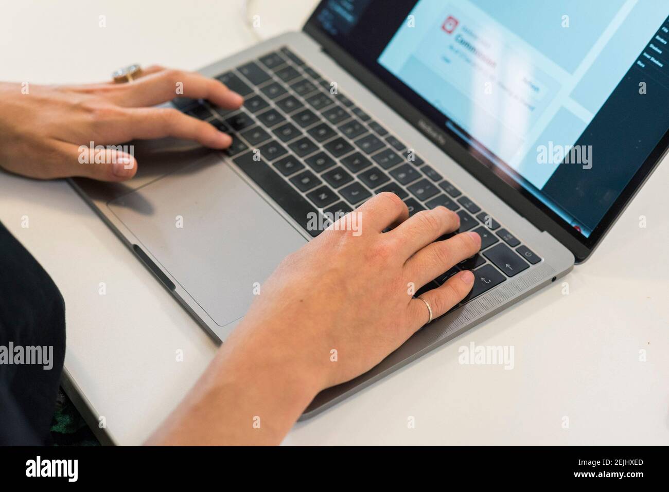 Una persona lavora e digita su un computer portatile Foto Stock