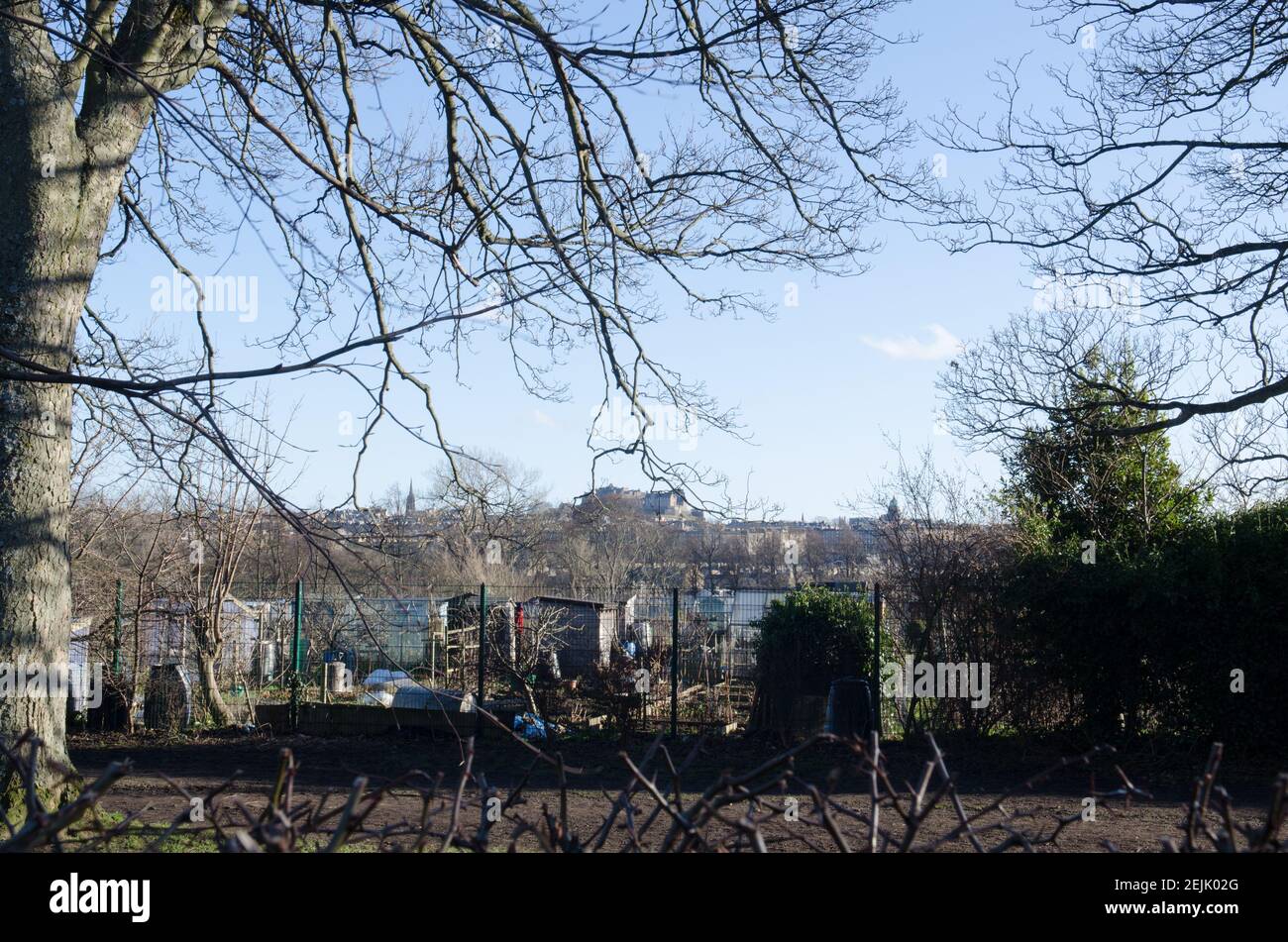 Giardino nel centro della città con vista sul Castello di Edimburgo e donna scavando Foto Stock