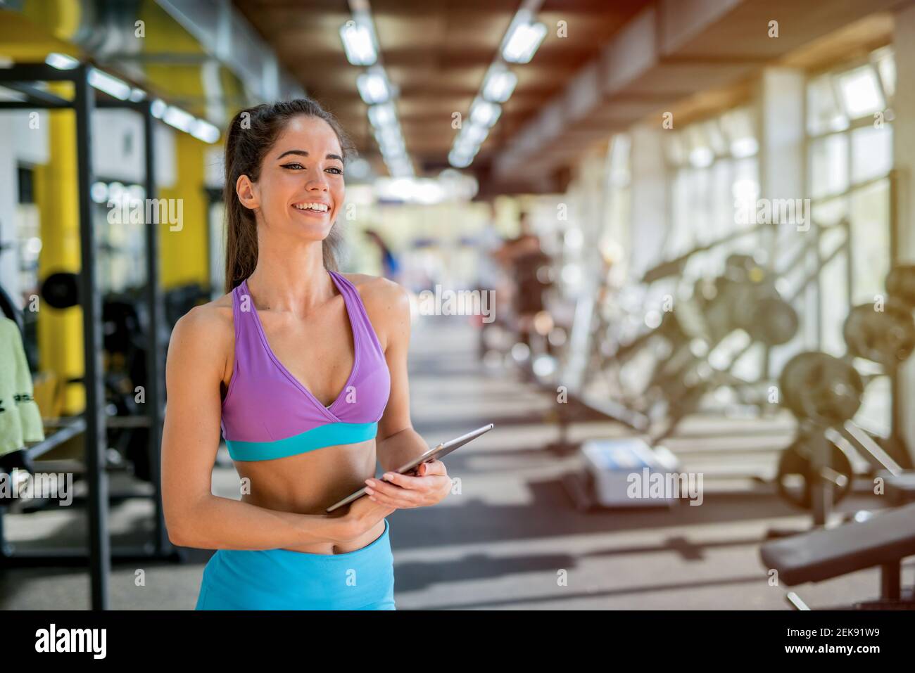 Immagine di bella forma sportiva personal trainer femminile di fitness in  posa davanti alla macchina fotografica in palestra luminosa Foto stock -  Alamy