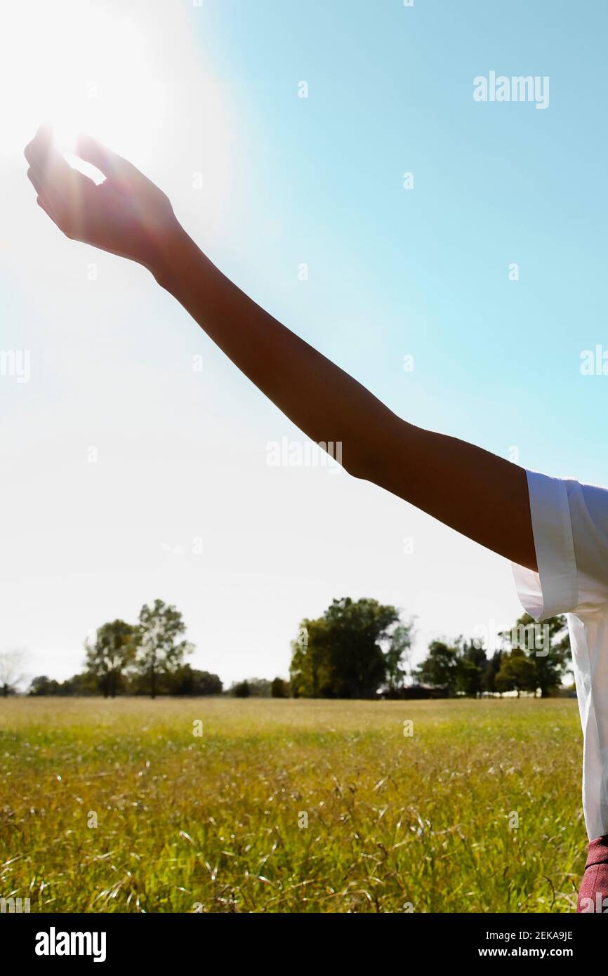 Donna con il braccio disteso in un campo Foto Stock