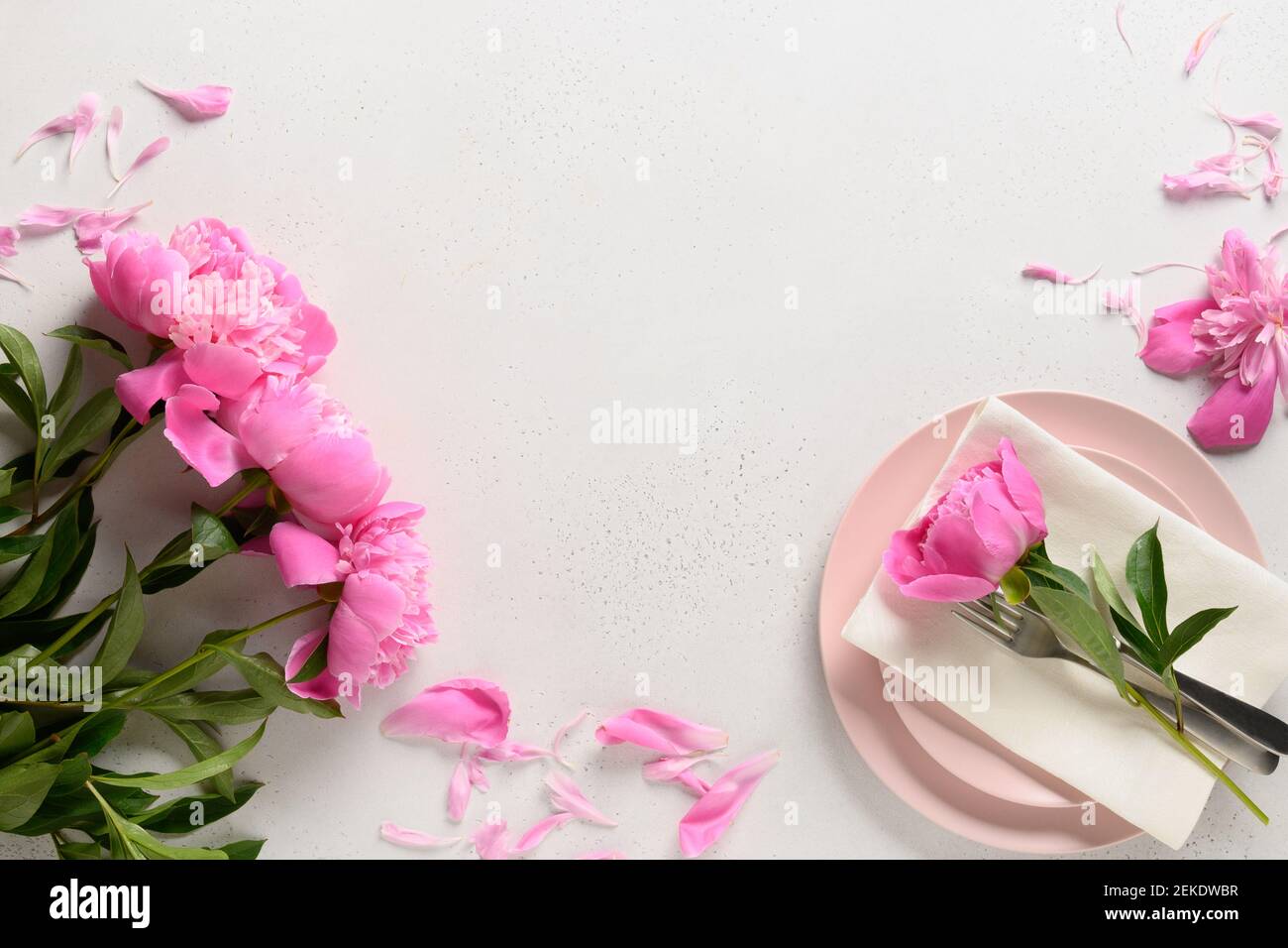 Elegante tavolo primaverile con pony rosa su tavolo bianco. Vista dall'alto. Spazio di copia. Foto Stock