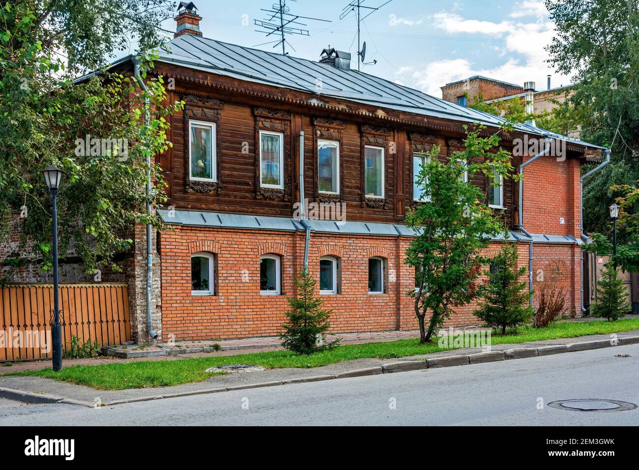 Tomsk, un antico palazzo di appartamenti in legno con un primo piano ricostruito Foto Stock