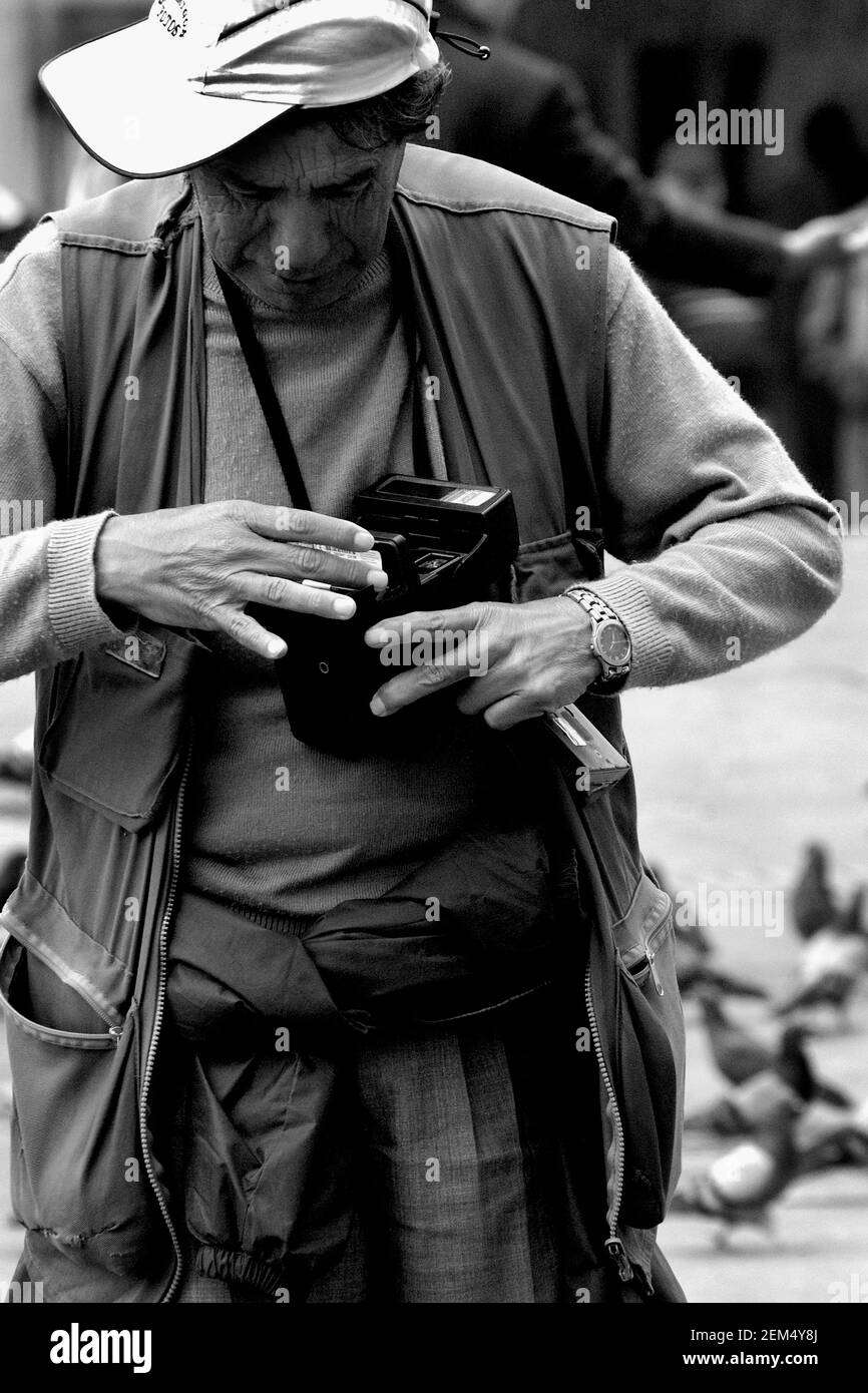 Primo piano di un fotografo che regola la sua fotocamera Foto Stock