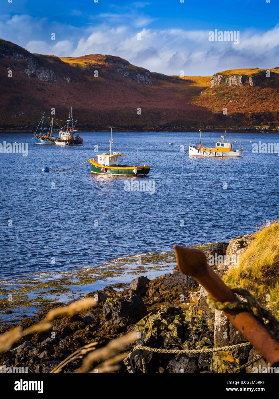 Barche da pesca all'ancora in una tranquilla baia sul Isola di Skye in Scozia Foto Stock