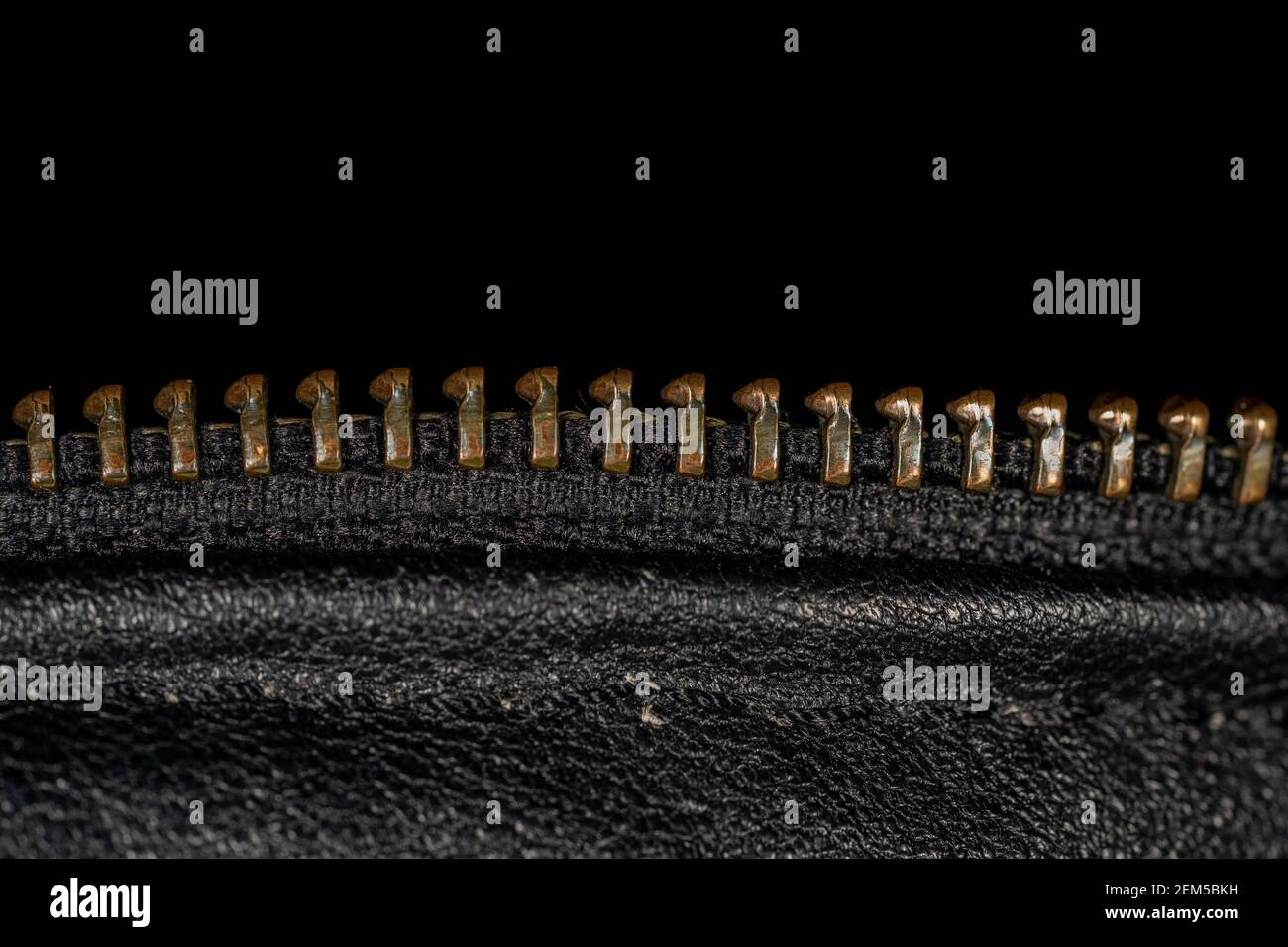 Dettaglio della chiusura lampo sulla giacca in pelle nera. Primo piano della macro con messa a fuoco locale. Vista fotografica macro verticale. Foto Stock