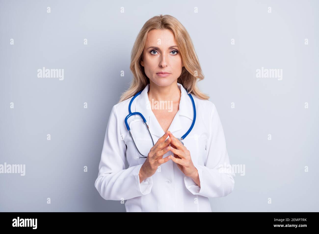 Ritratto di affascinante serio signora braccia dita insieme pensare guardare telecamera isolata su sfondo grigio Foto Stock