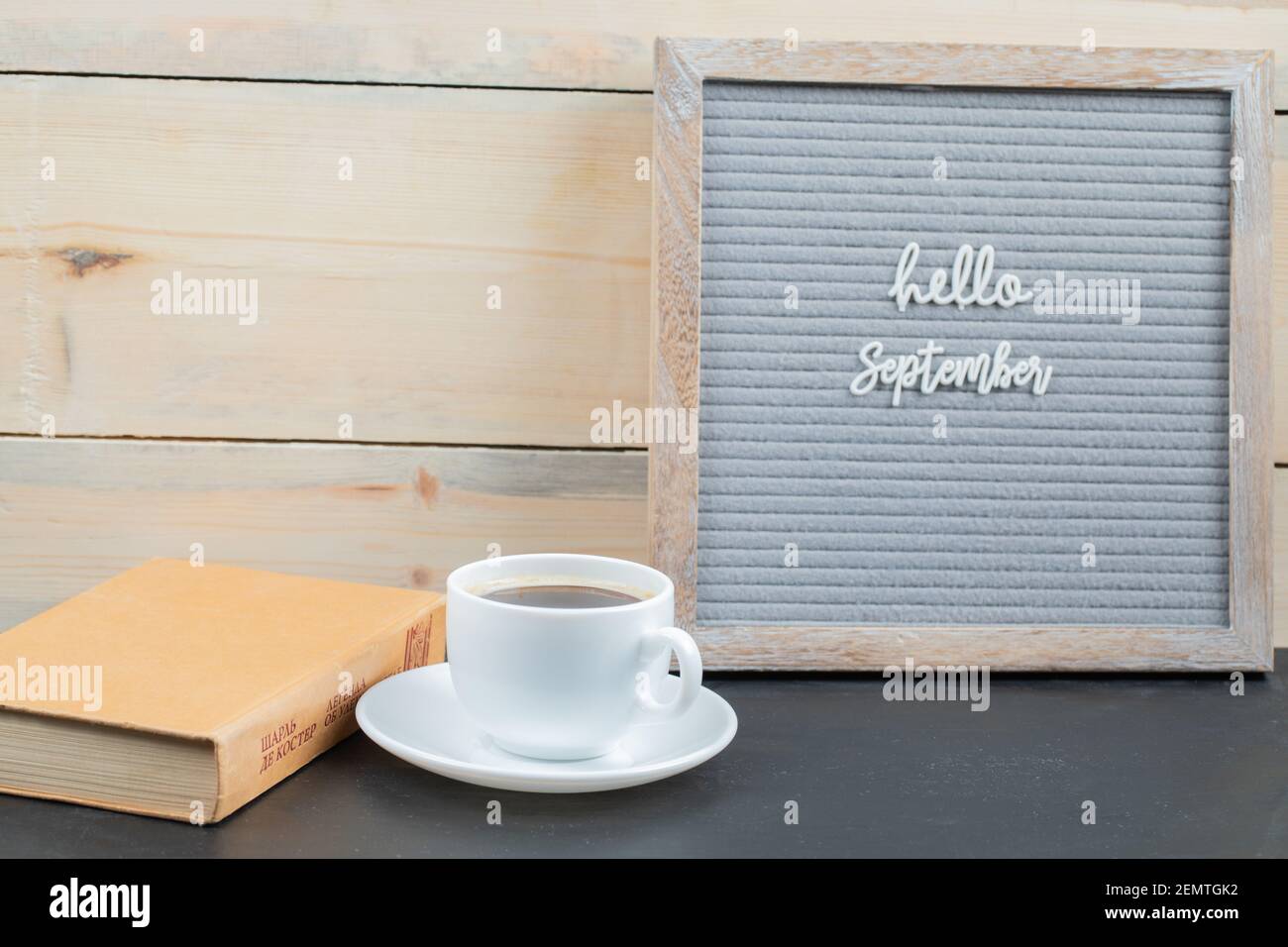 Ciao settembre poster incorporato su sfondo grigio con una tazza di bevanda da parte Foto Stock