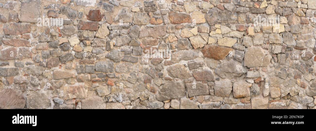Vecchio muro di pietra naturale panoramico grigio marrone Foto Stock