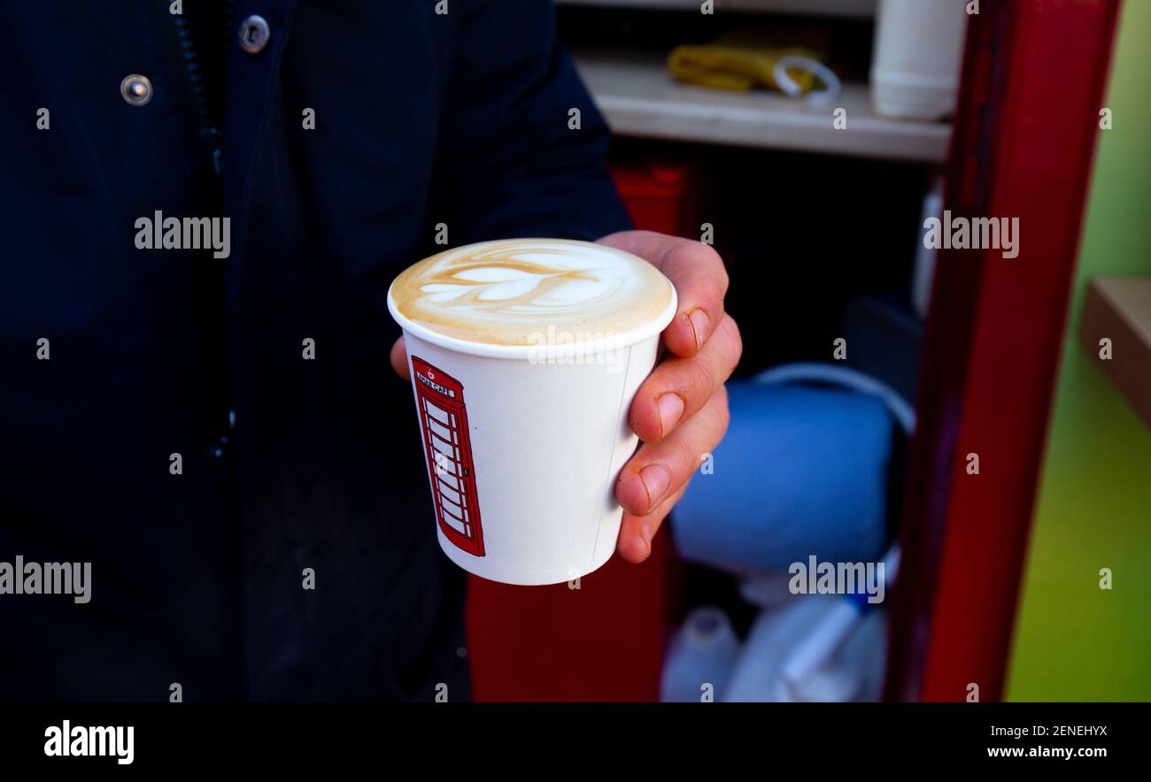 Londra, Regno Unito. 26 Febbraio 2021 UNA cabina telefonica in King Street Twickenham si è convertita ed ha aperto questa settimana come un chiosco caffè / bar / stand. Amar Cafe noleggiare lo stand e hanno installato tutto ciò che è necessario per barista fatto specialità caffè colombiano a 100 metri dal fiume Tamigi. Carlos era il barista e si prendono solo pagamenti con carta di credito. La cabina ha l'alimentazione che esisteva già da quando era un telefono a pagamento e l'acqua è imbottigliata e portata sul posto. Hanno cabine simili a Chiswick e Greenwich. Andrew Fosker / Alamy Live News Foto Stock