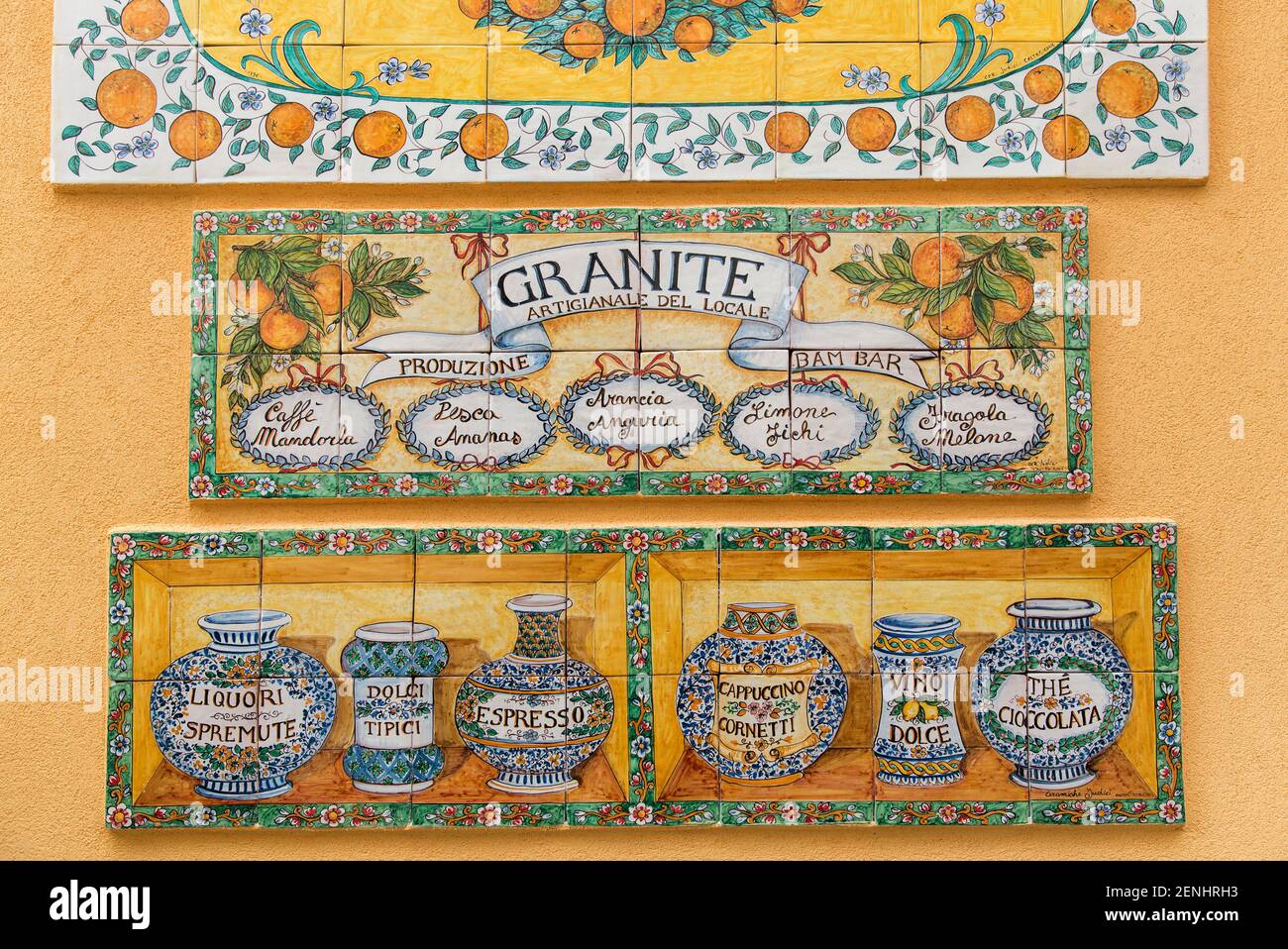 Italia,Sicilia,Taormina, piastrelle all'esterno di un edificio che raffigura la cultura siciliana e la pubblicità del granito Foto Stock