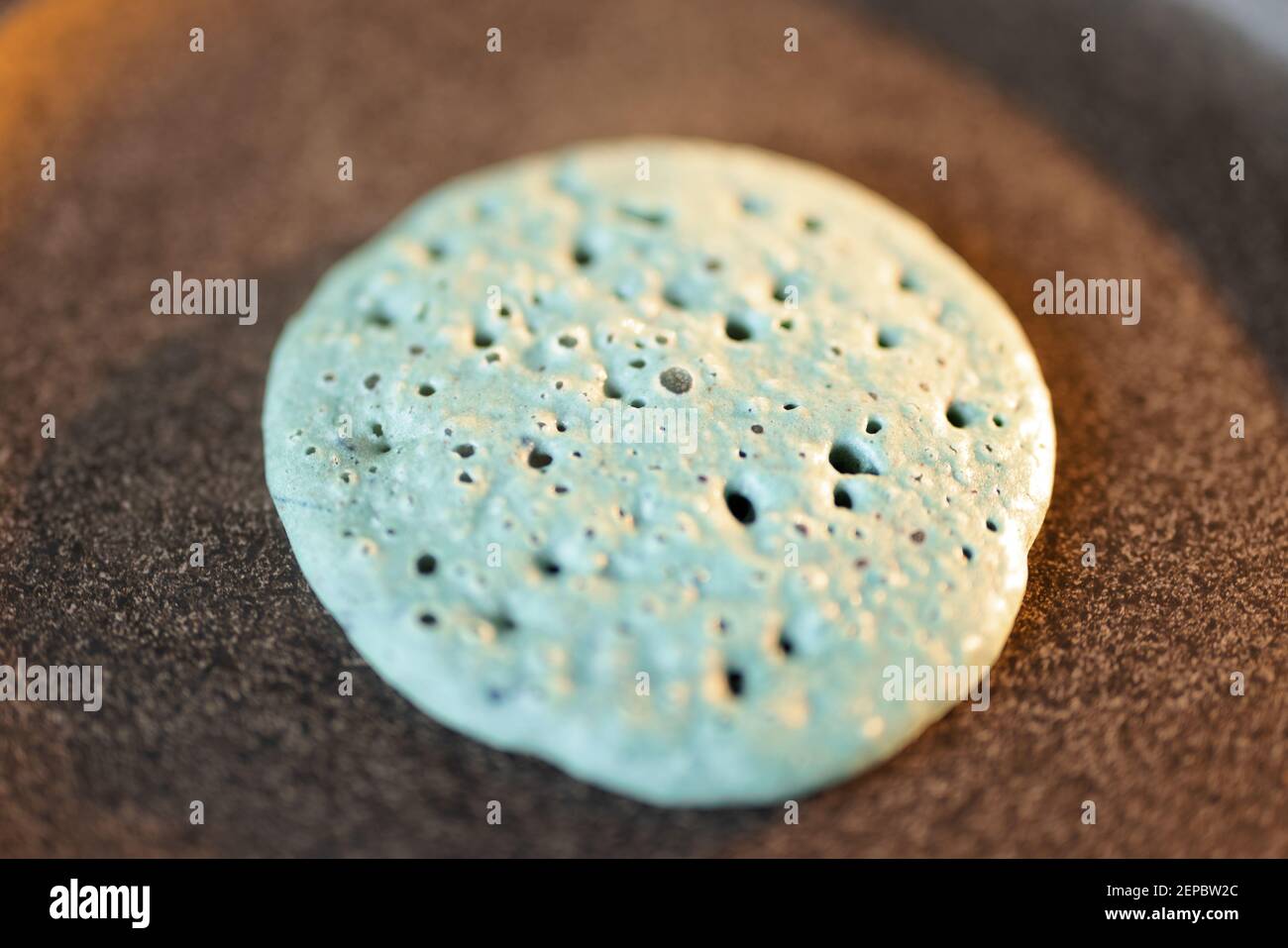Deliziosi pancake blu su una padella antiaderente. Foto Stock