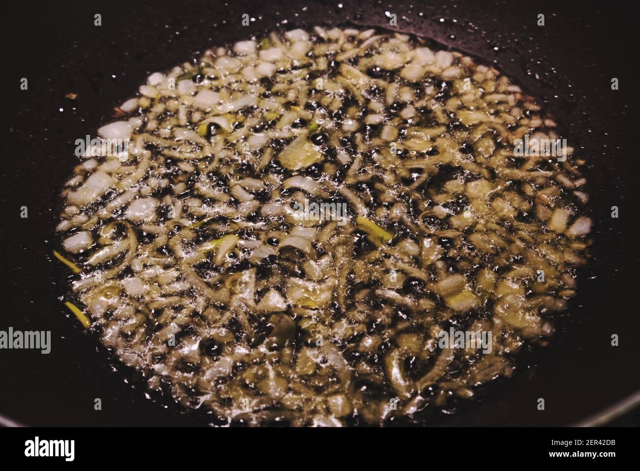 Primo piano di cipolla saltata in una padella Foto Stock