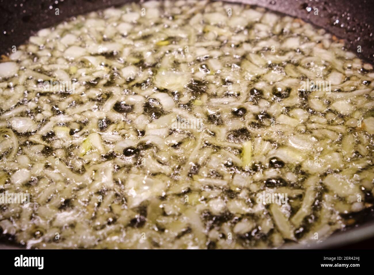 Primo piano di cipolla saltata in una padella Foto Stock