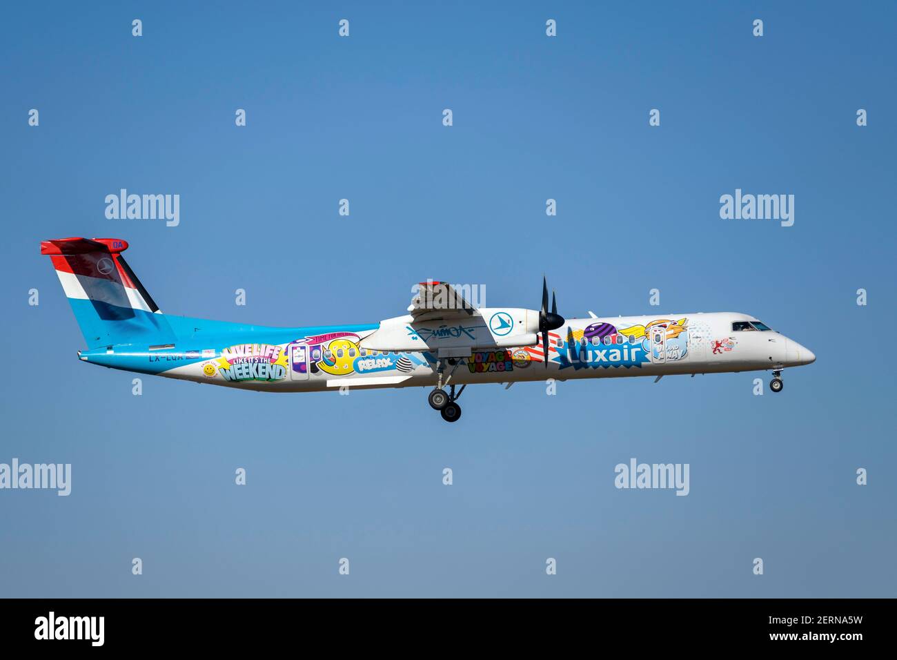 Monaco, Germania - Febbraio 28. 2021 : Luxair Bombardier DHC-8-400 con registrazione aereo LX-LQA in avvicinamento alla pista meridionale 08R di Foto Stock