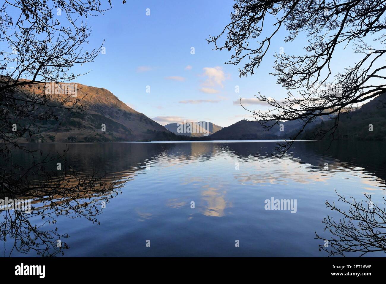 Ullswater, come il sole è basso nel cielo, guardando a sud verso Patterdale, Lake District National Park, Cumbria, Inghilterra, Regno Unitred Foto Stock