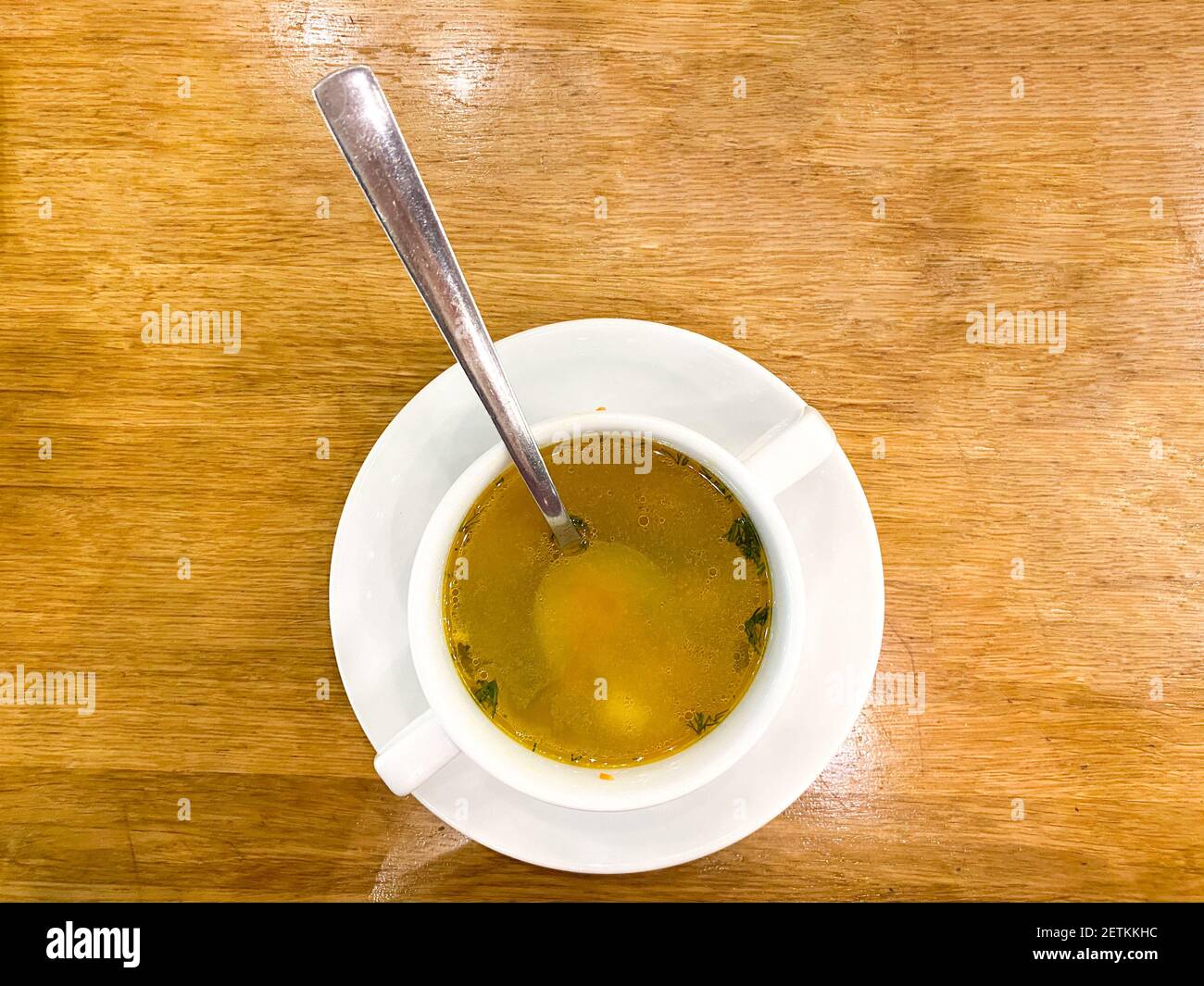 Una ciotola di zuppa di pollo su sfondo di legno Foto Stock