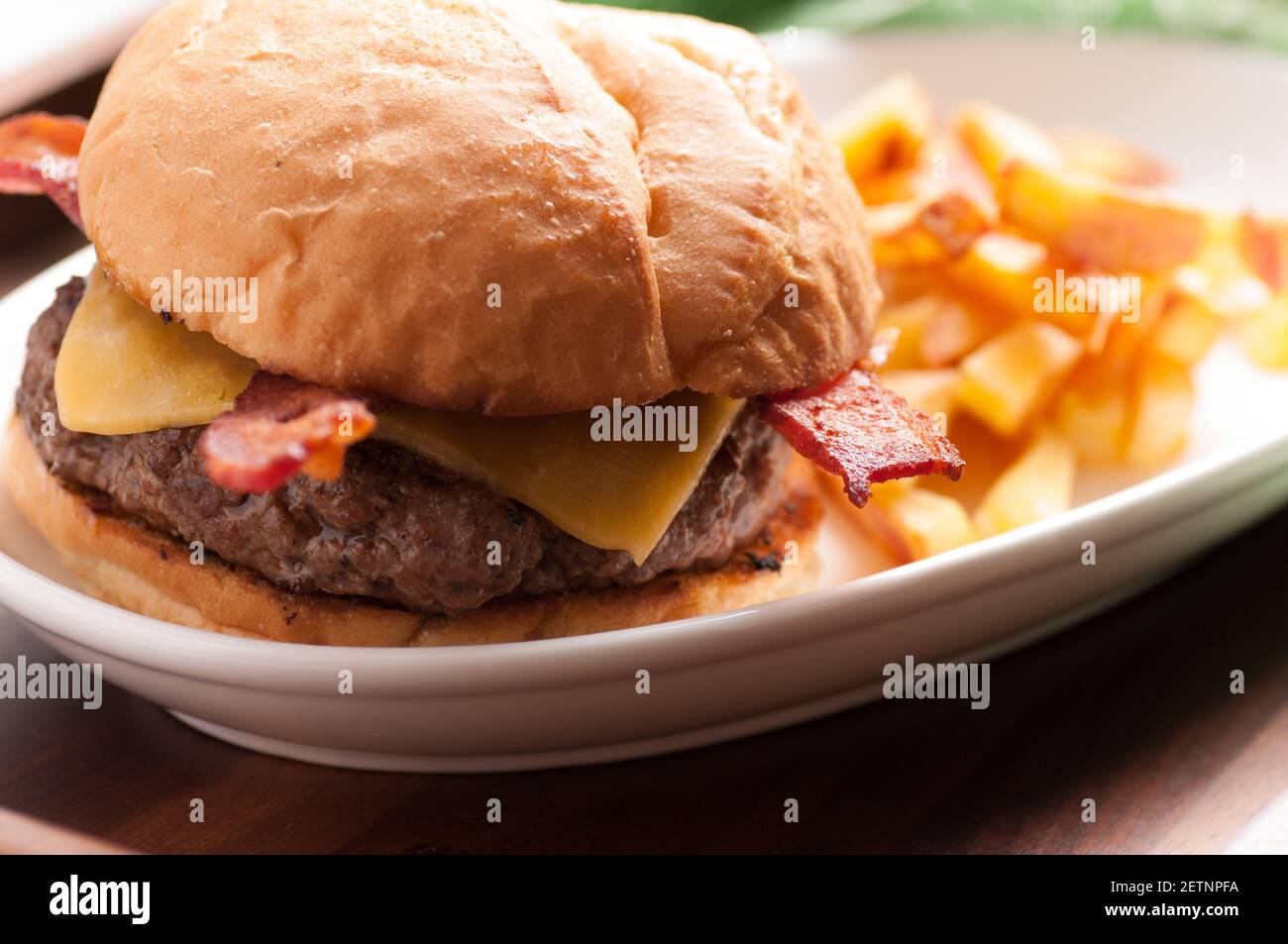 hamburger biologico fresco fattoria con pancetta e formaggio con casa patatine fritte fatte Foto Stock