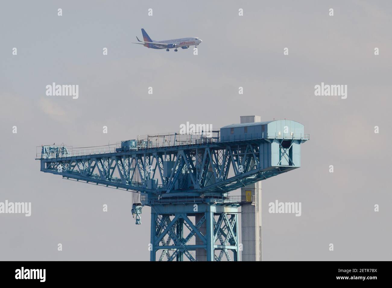 Un Jet2 737-800 per l'aeroporto di Glasgow che vola sopra la gru Titan, Clydebank Foto Stock