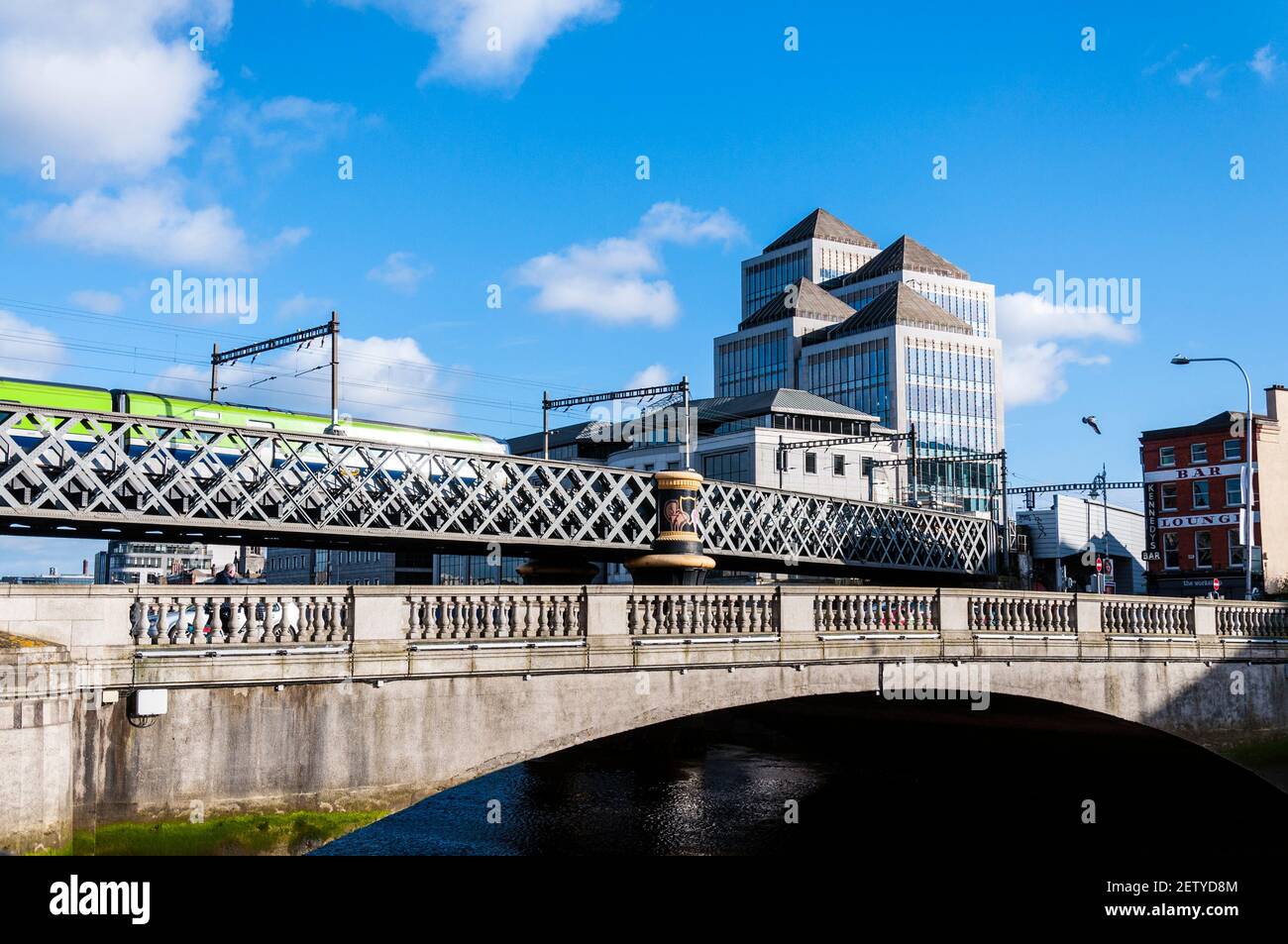 Ponti sul fiume Liffey, con il treno DART, la sede centrale della Ulster Bank sul lato destro. Dublino, Irlanda Foto Stock