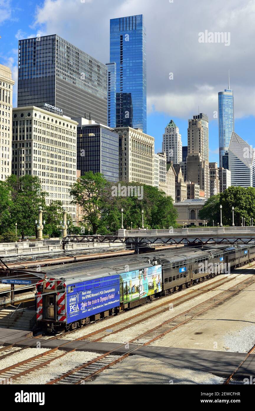 Chicago, Illinois, Stati Uniti. Un treno per pendolari Metra, completo di pubblicità su una delle sue auto, che arriva alla stazione di Van Buren Street. Foto Stock