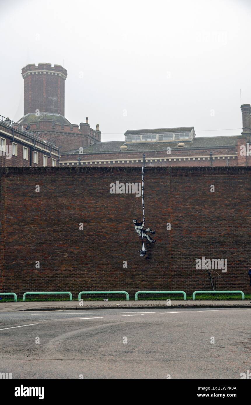 Reading, UK - 3 marzo 2021: Vista della prigione di lettura con un pezzo di arte di strada di Banksy che mostra un condannato che sfugge sul muro con un Foto Stock