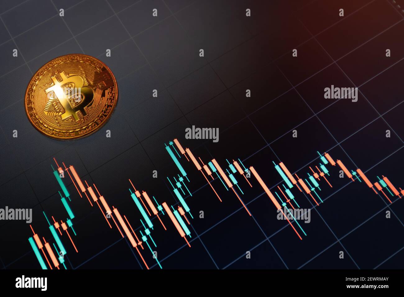 Moneta criptovaluta Bitcoin sullo sfondo del grafico Foto Stock