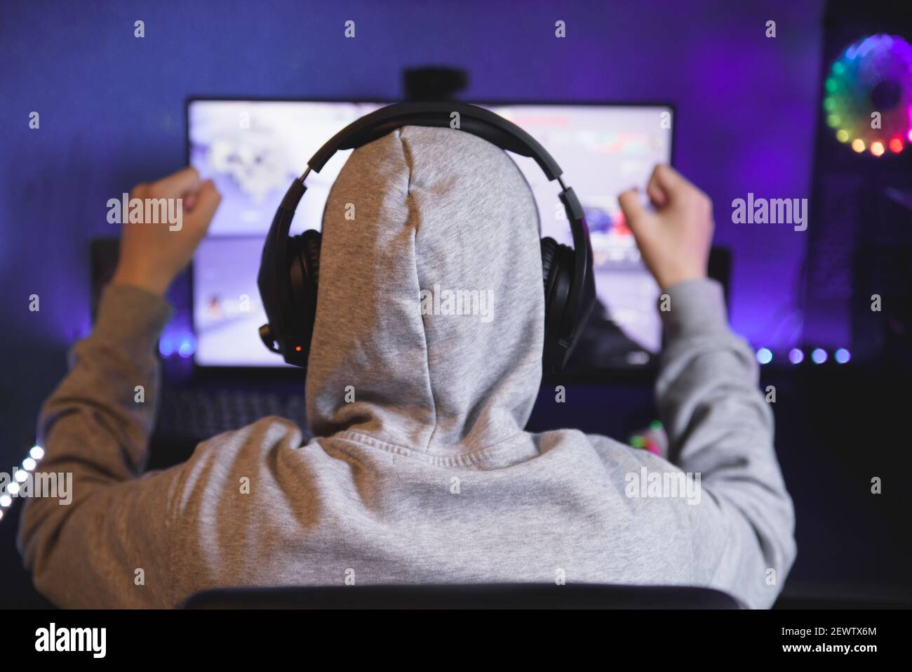 Giovani gamer riproduzione di video gioco di indossare le cuffie Foto Stock