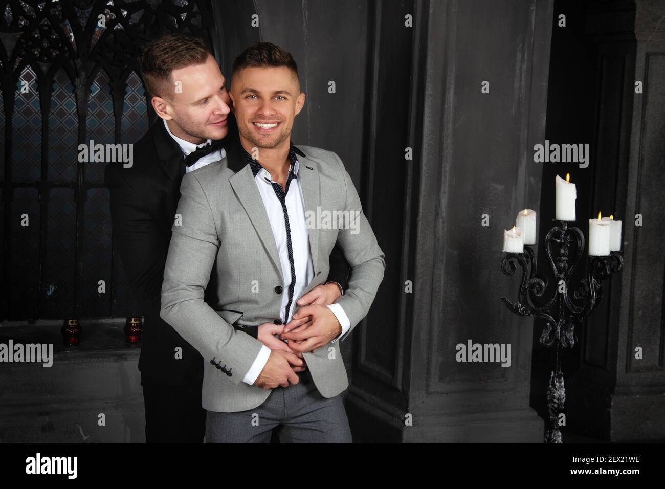 Giovane coppia gay felice sposarsi in chiesa. Amore e romanticismo. Bei uomini in abiti. Foto Stock