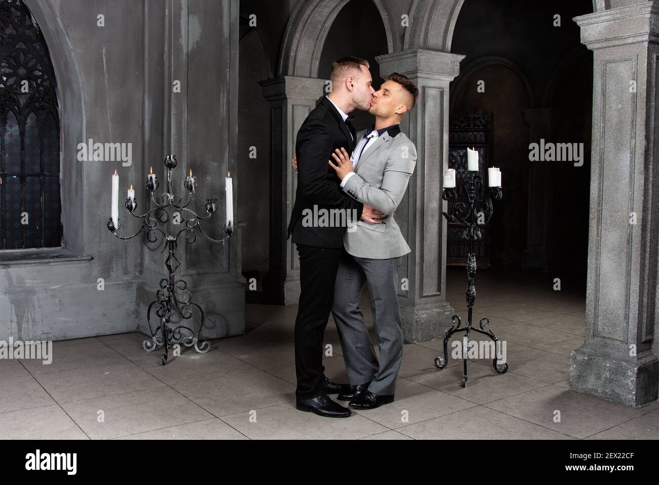Giovane coppia gay felice sposarsi in chiesa. Amore e romanticismo. Bei uomini in abiti. Foto Stock
