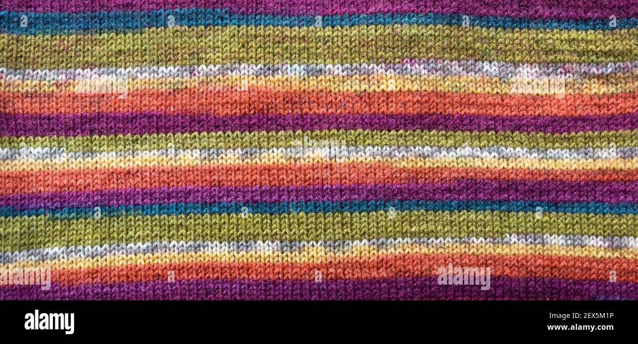 Unisci modello. Primo piano di tessuto di lana lavorato a maglia. Motivo colorato Unione come sfondo. Foto Stock