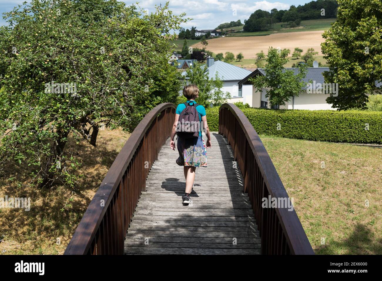 Welschbilig, Renania-Palatinato / Germania - 08 08 2020: Ragazza attraente che cammina su un ponte di legno Foto Stock