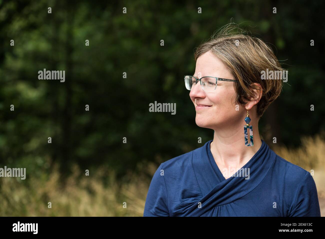 Ritratto di una donna di trent'anni con una natura sfondo in bokeh Foto Stock