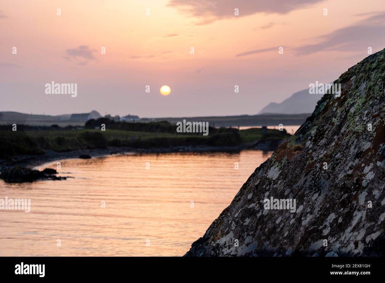 Sole serale basso su Portmagee Bay, Contea di Kerry Irlanda Foto Stock