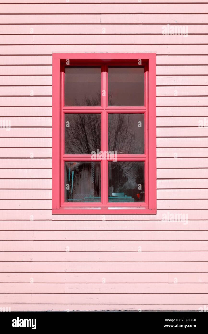 Edificio in clapboard e finestra dipinta di rosa Foto Stock