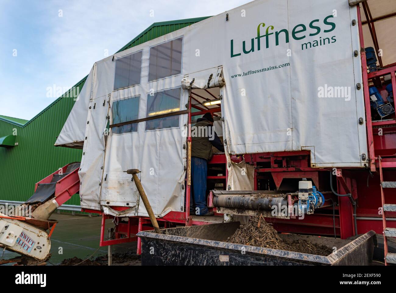 Macchine agricole in cortile per la raccolta di carote presso la Luffness Mains Farm, East Lothian, Scozia, Regno Unito Foto Stock