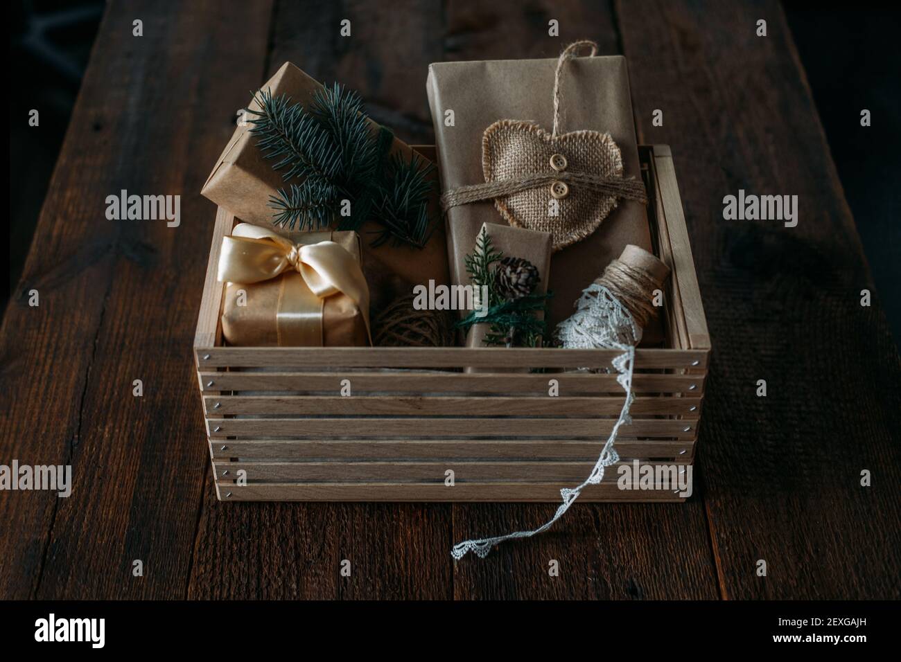 Natale sostenibile, regali zero rifiuti, decorazioni naturali di Natale. Confezione regalo di Natale in carta marrone riciclata in scatola di cura di legno. Stile vintage Foto Stock