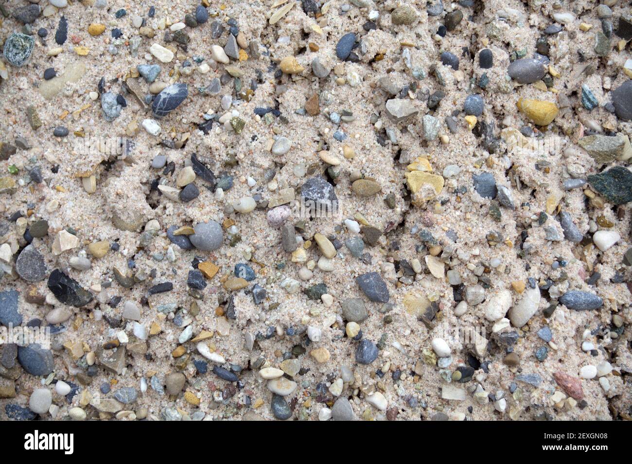 sabbia e pietre texture di sfondo. Materiale di sabbia ghiaiosa Foto Stock