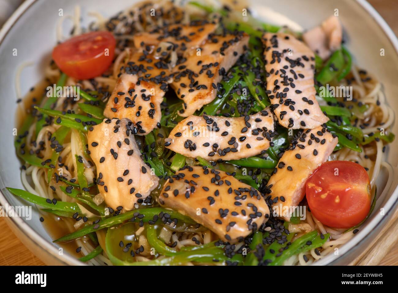 Ricetta vietnamita, insalata di noodle calda con salmone e piselli dolci, Bo Bun, piselli dolci, salmone, pomodoro, salsa teriyaki, Noodle Foto Stock