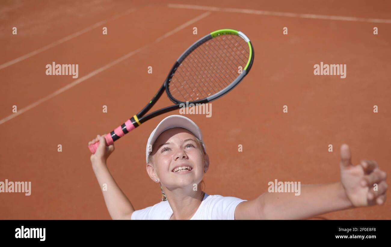 Un giovane tennista serve nel gioco. Foto Stock