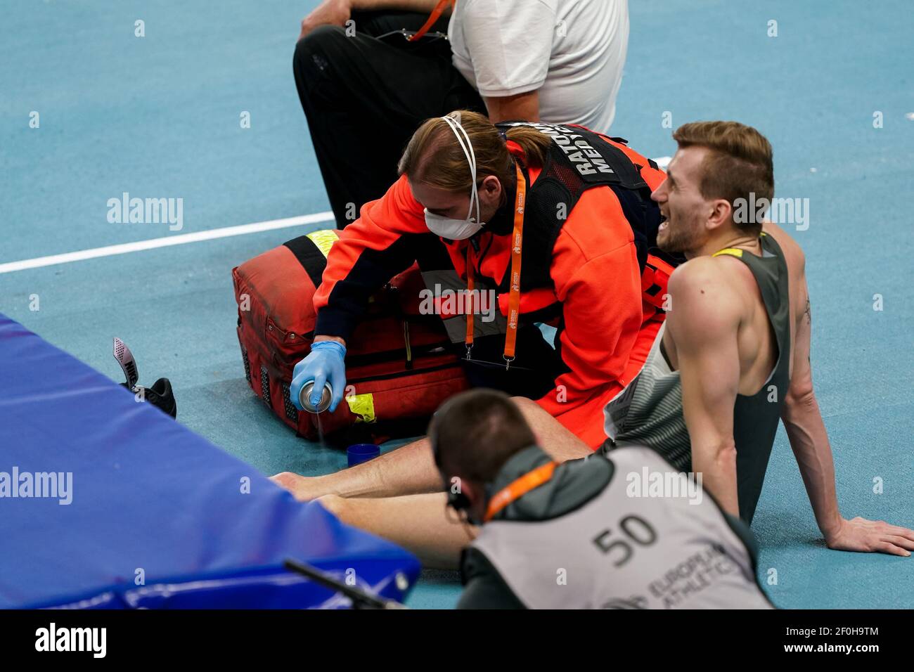TORUN, POLONIA - 7 MARZO: Mateusz Przybylko della Germania riceve cure mediche mentre gareggia nella finale di Mens High Jump durante l'europeo Athle Foto Stock